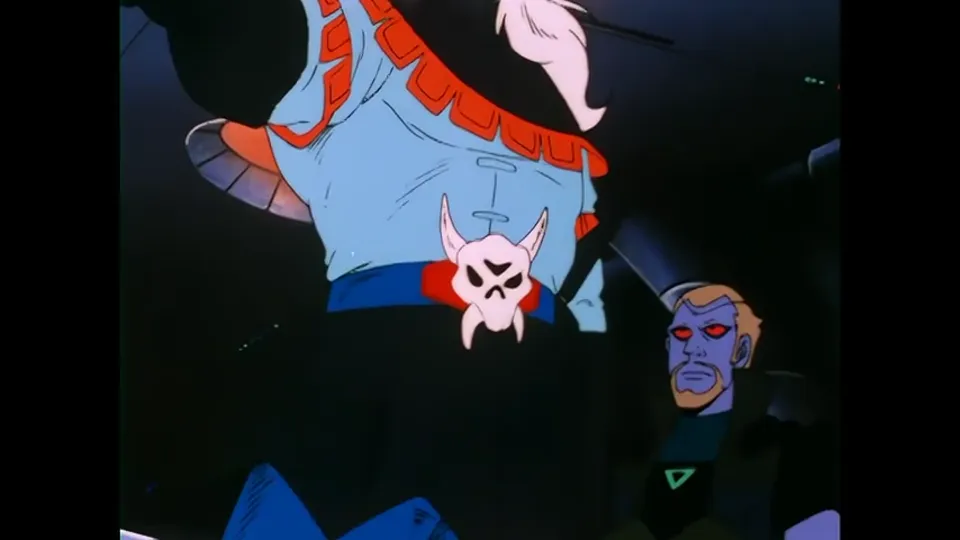 Voltron’s head with a skull device on the brow, and a face below it.