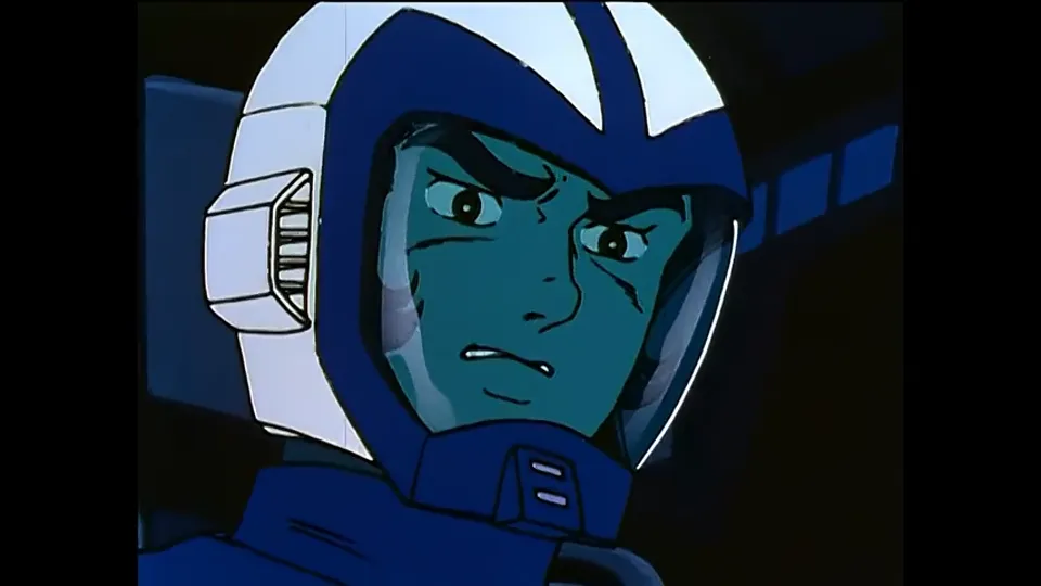 A pilot in a blue helmet, jaw set.