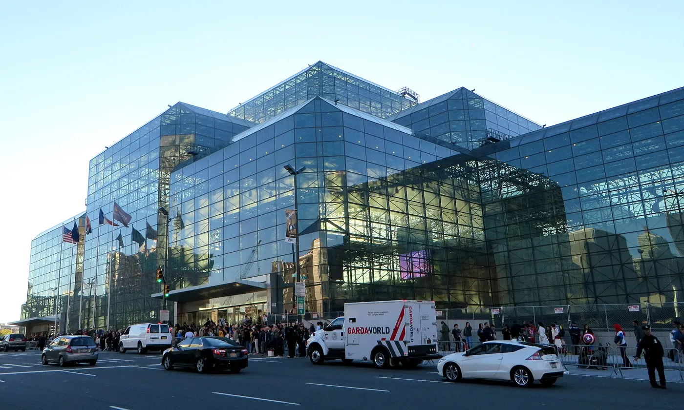 The Javits Center exterior on a clear day, the glass facade facing the Hudson side of Manhattan